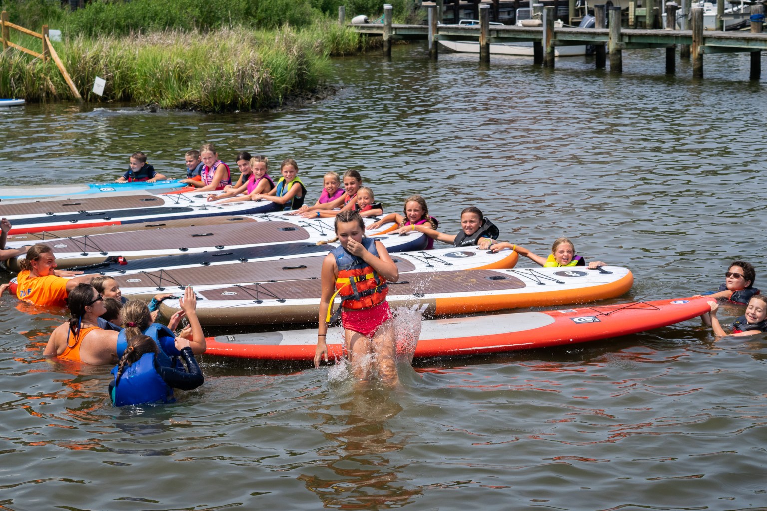 a group of people in a small boat in a body of water