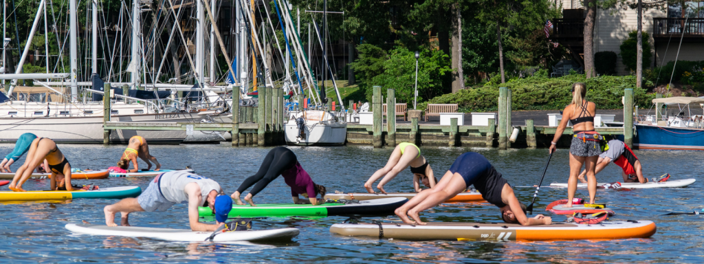 a group of people rowing a boat in the water