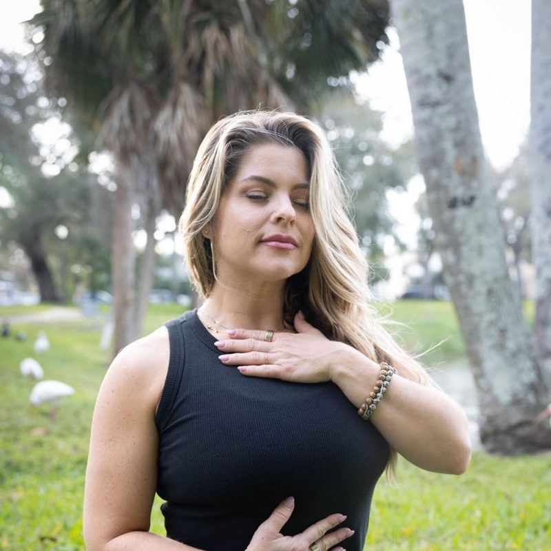 a woman sitting on the grass