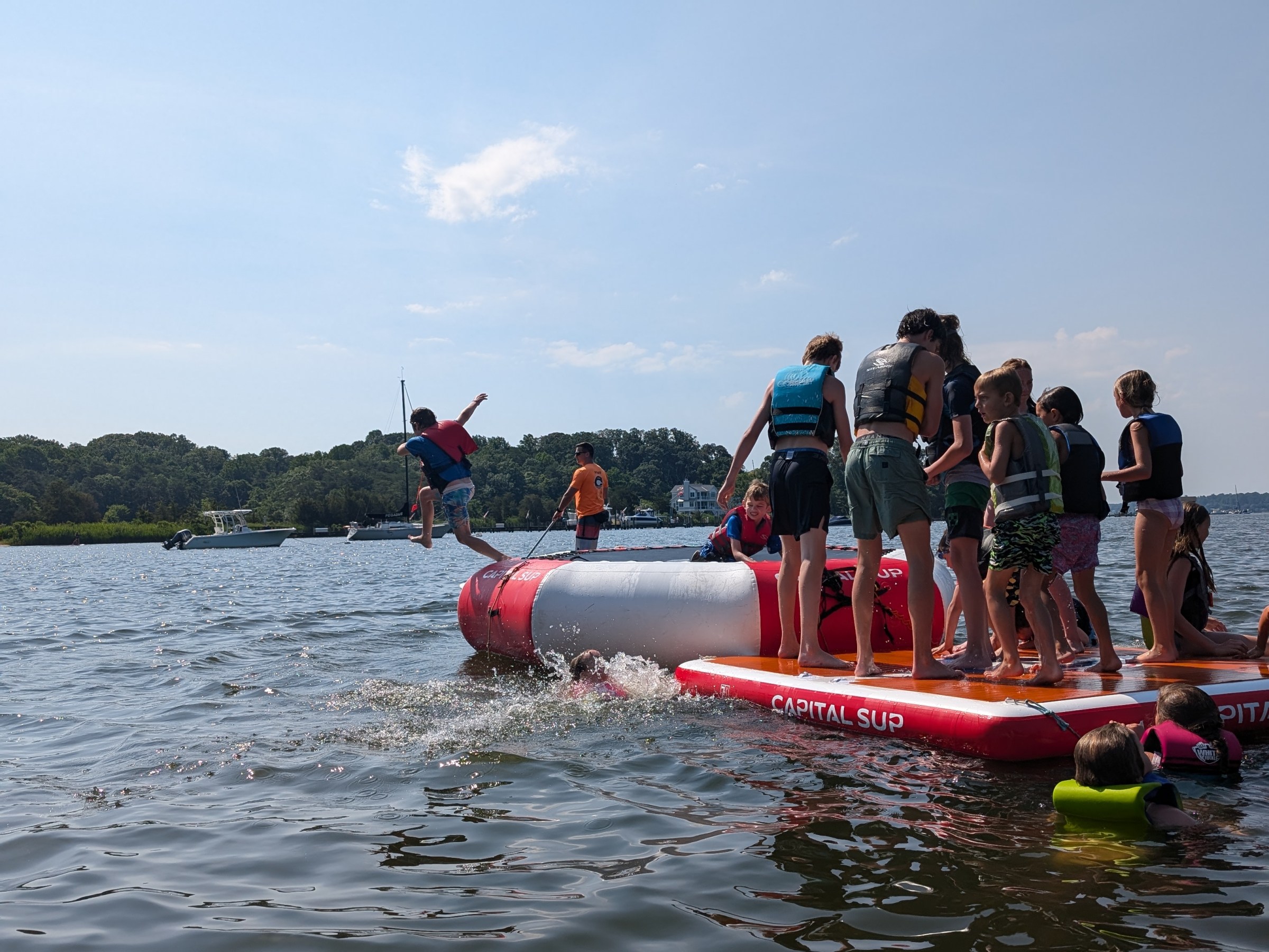 a group of people in a small boat in a body of water