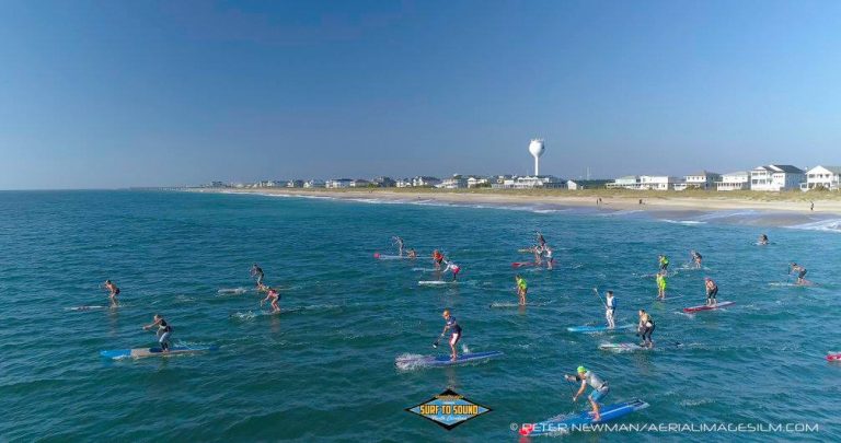 a group of people riding skis on a body of water