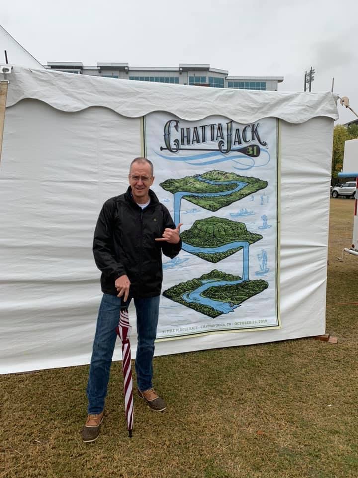 a man next to a ChattaJack poster