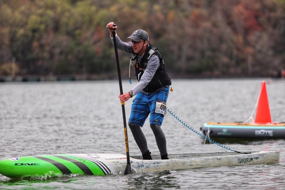 a person riding on the back of a boat in the water