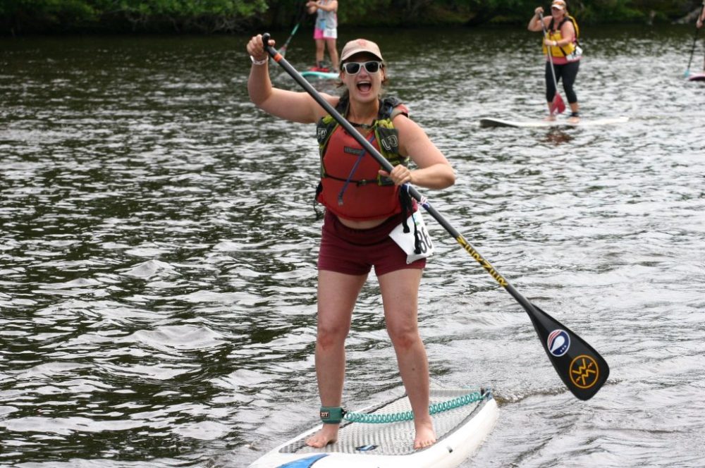 a person standing next to a body of water