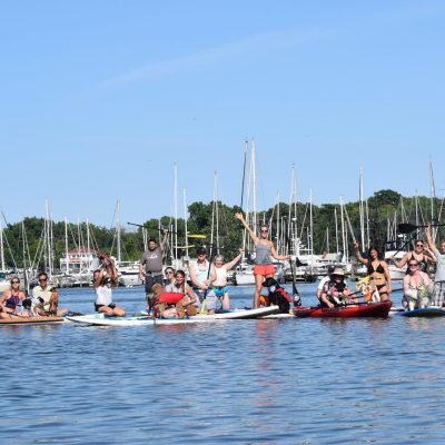 a group of people rowing a boat in the water