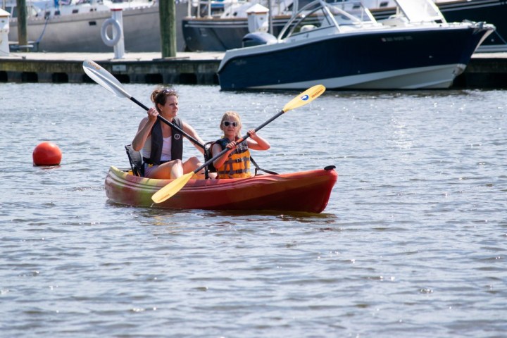 a group of people in a small boat in a body of water
