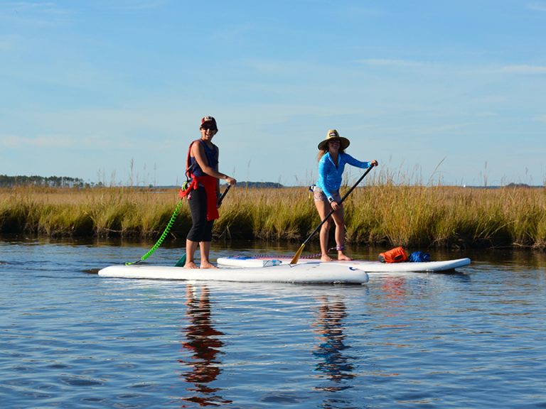 a group of people riding skis on a body of water
