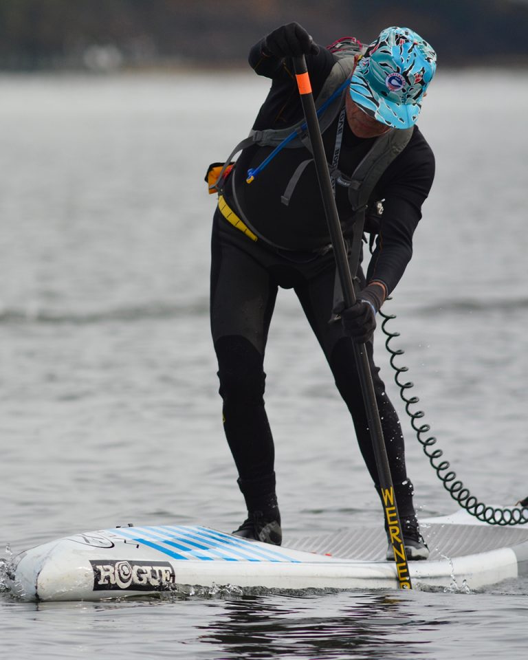 a person riding a surf board on a body of water