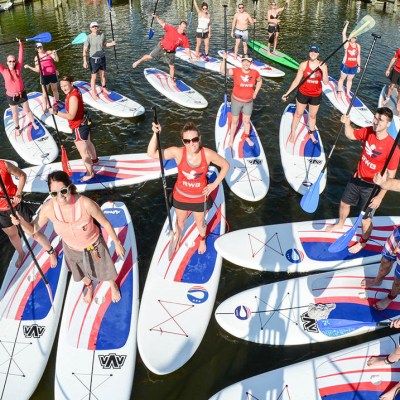 a group of people racing each other on a boat