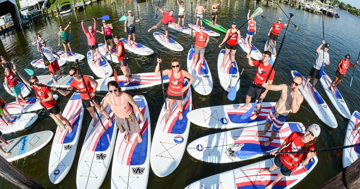 a group of people racing each other on a boat