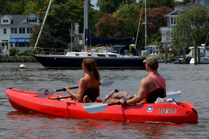 a group of people in a small boat in a body of water