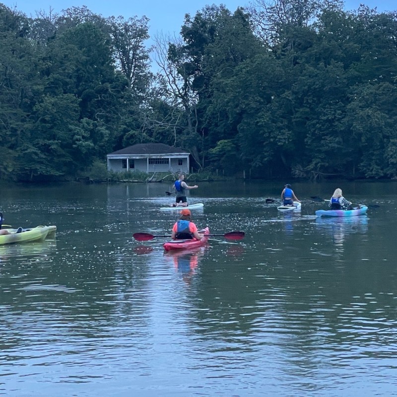 a group of people rowing a boat in the water