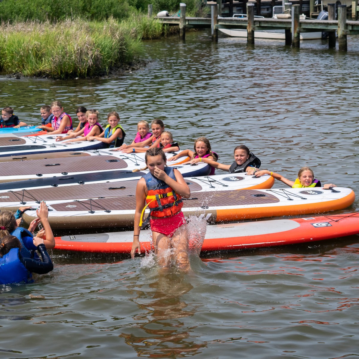 a group of people in a small boat in a body of water