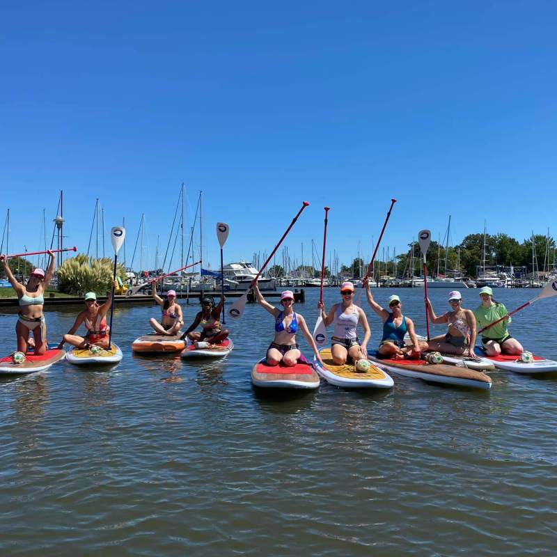 a group of people on SUP in a body of water