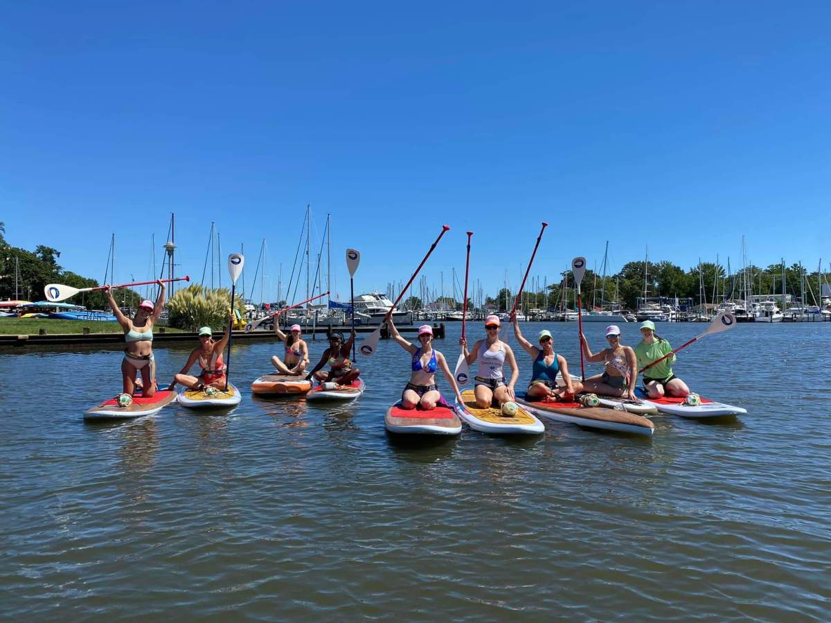 a group of people on SUP in a body of water