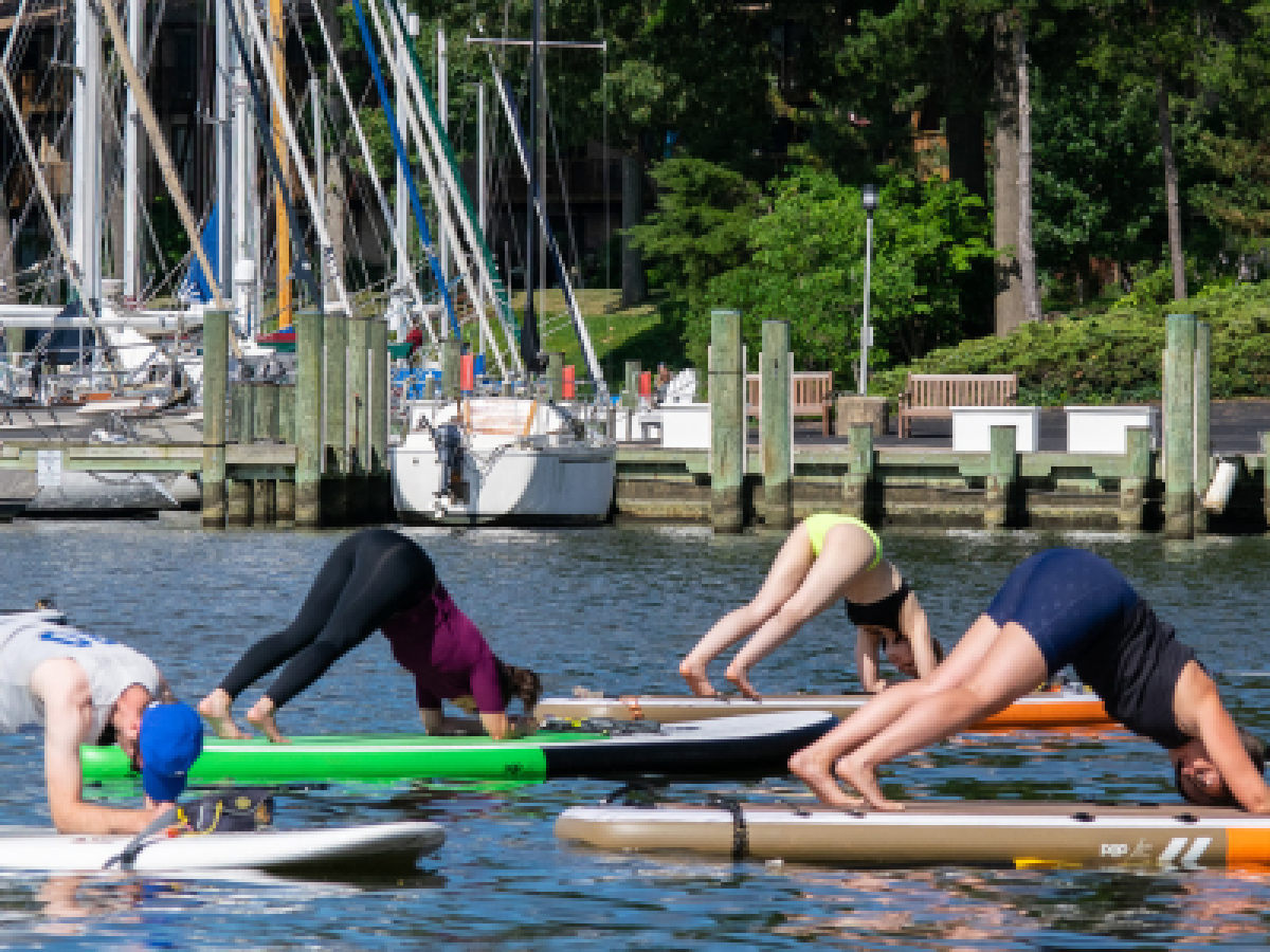 a group of people rowing a boat in the water
