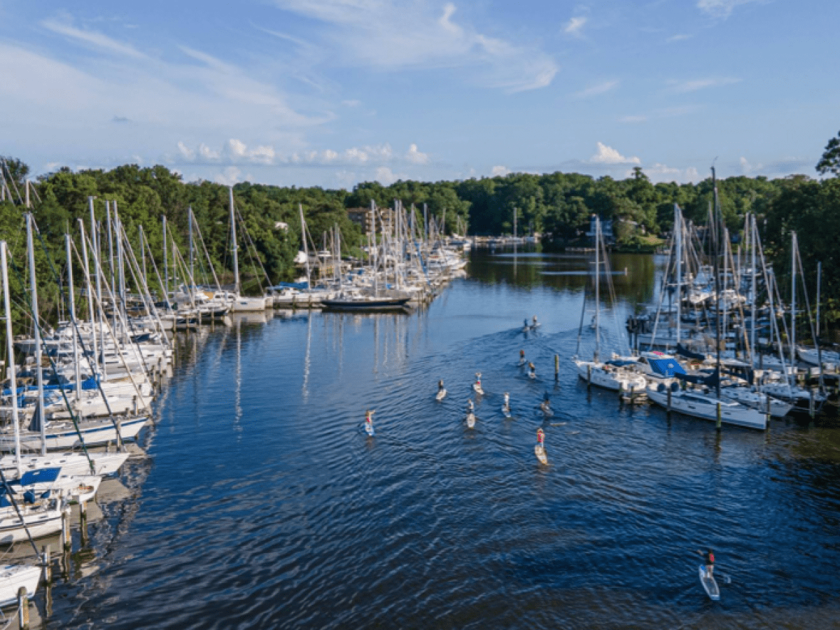 a small boat in a harbor next to a body of water