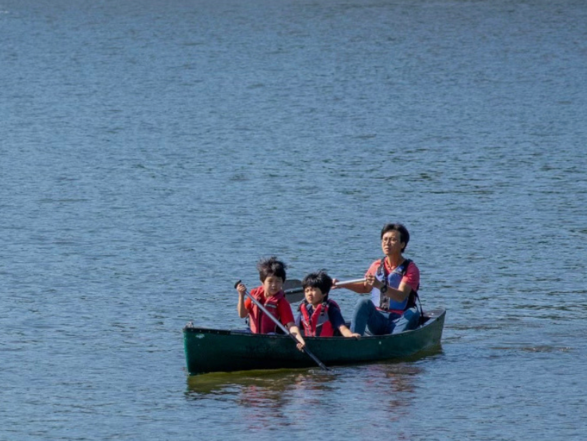 a group of people in a small boat in a body of water