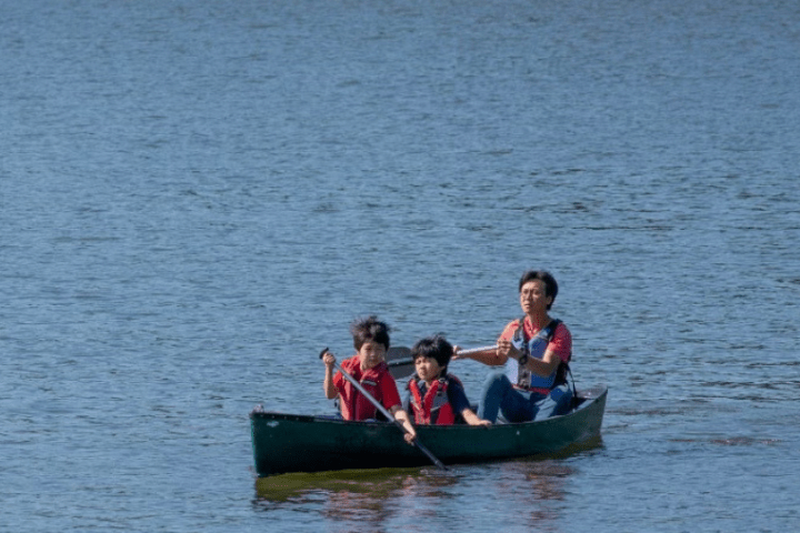 a group of people in a small boat in a body of water