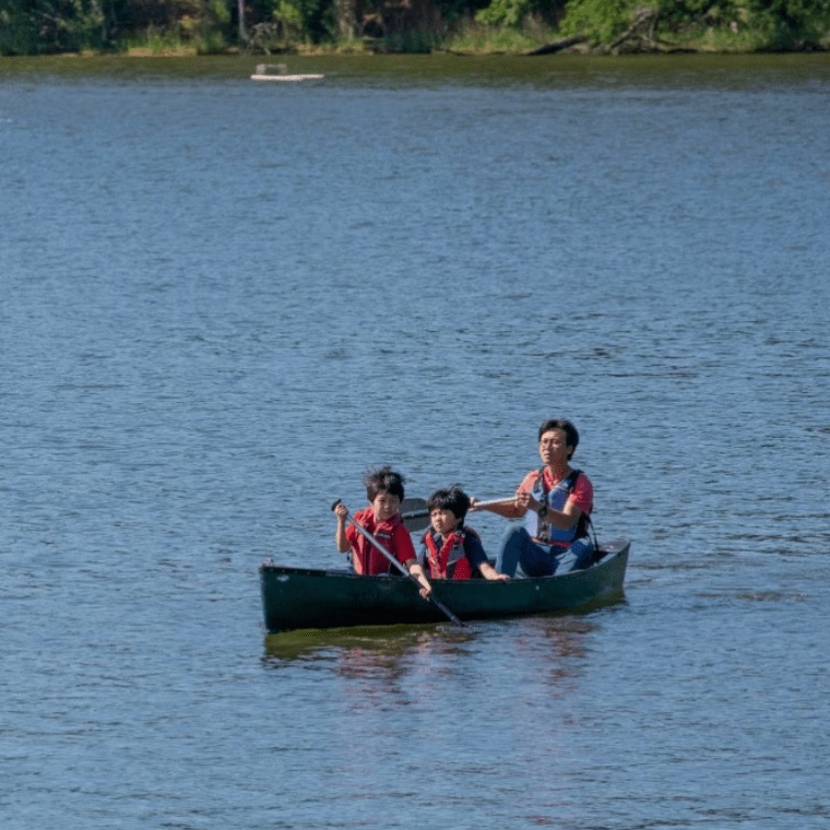 a group of people in a small boat in a body of water