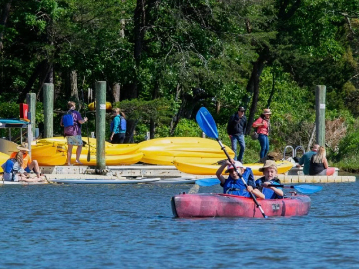 a group of people in a small boat in a body of water