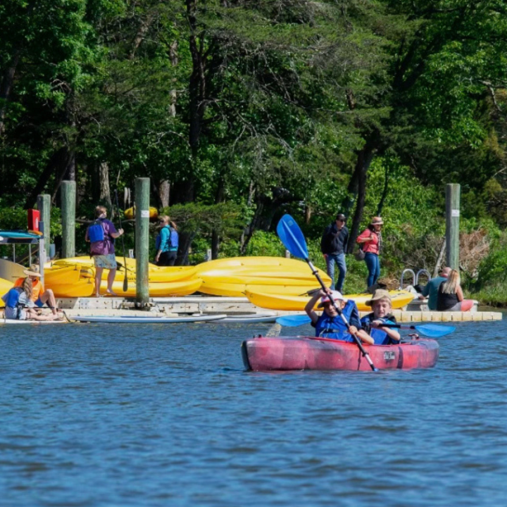a group of people in a small boat in a body of water
