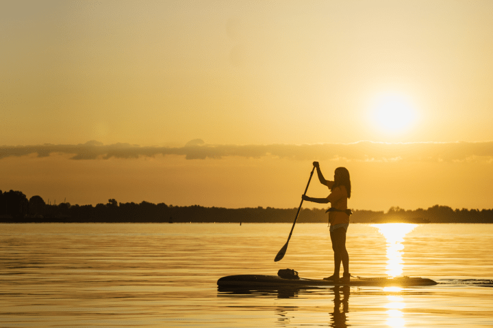 a man riding on the back of a boat in the water