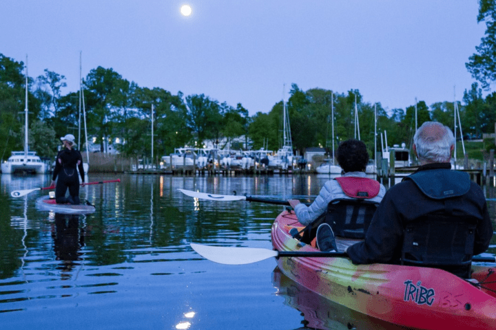 a group of people on a boat in the water