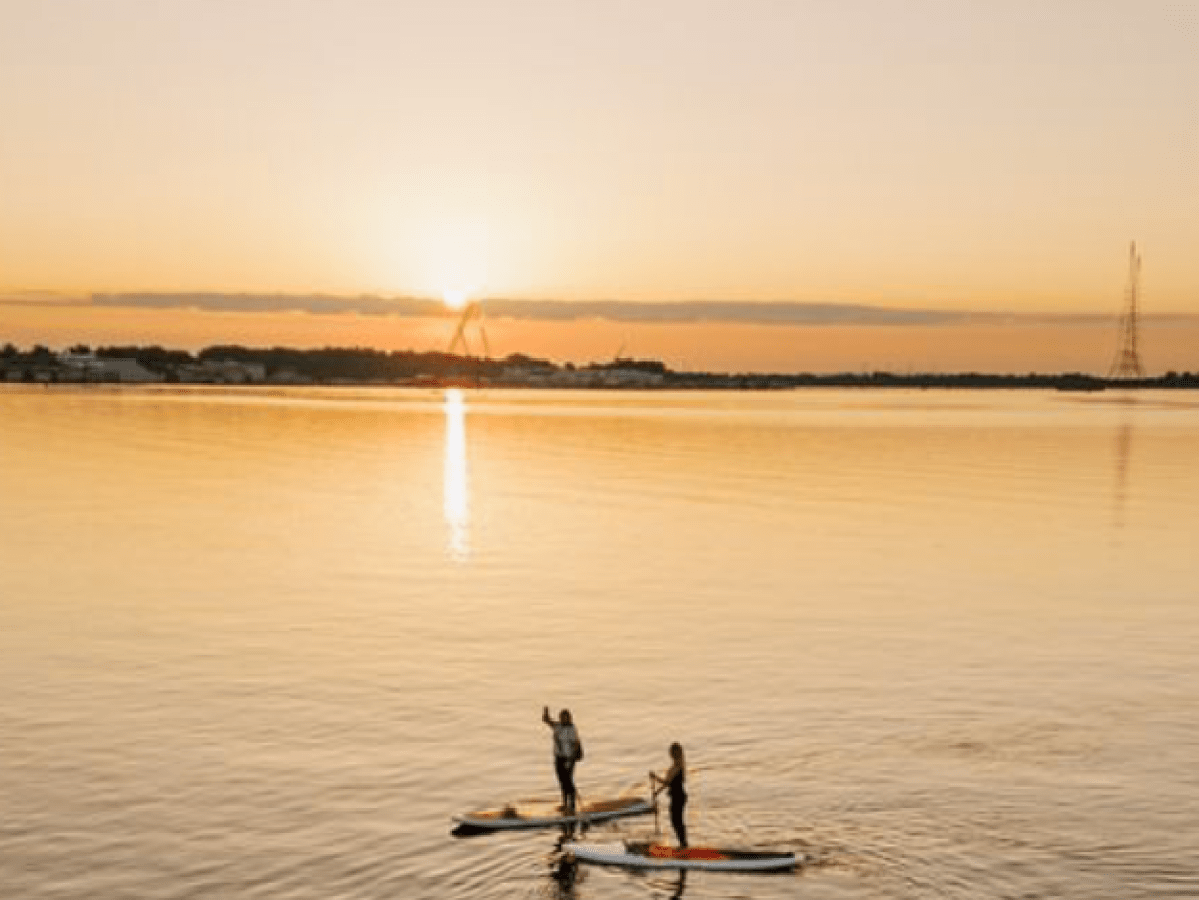 a person standing next to a body of water