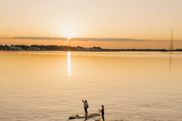 a person standing next to a body of water
