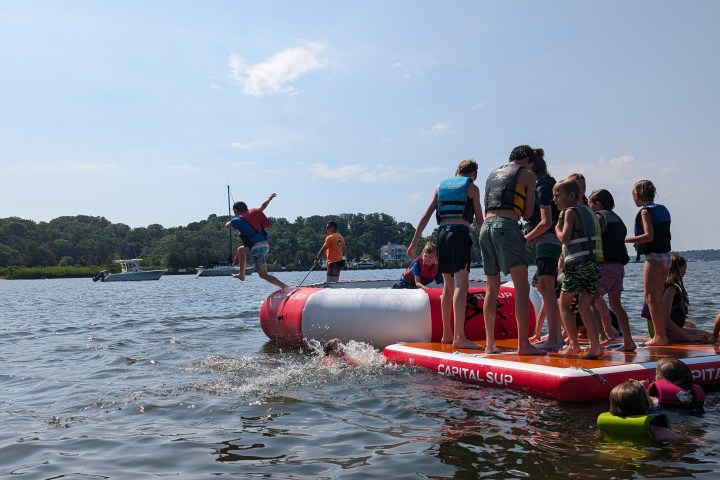 a group of people in a small boat in a body of water