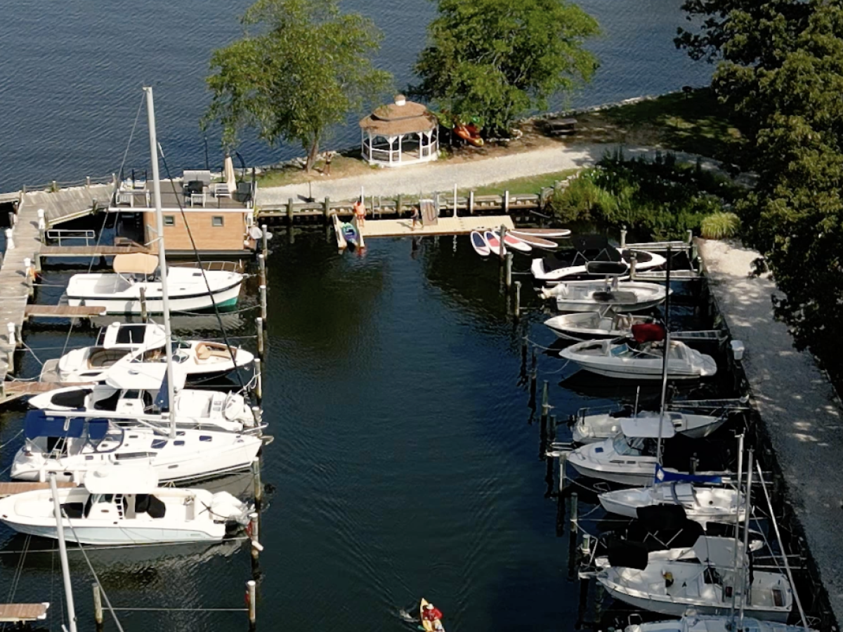 a small boat in a harbor next to a body of water
