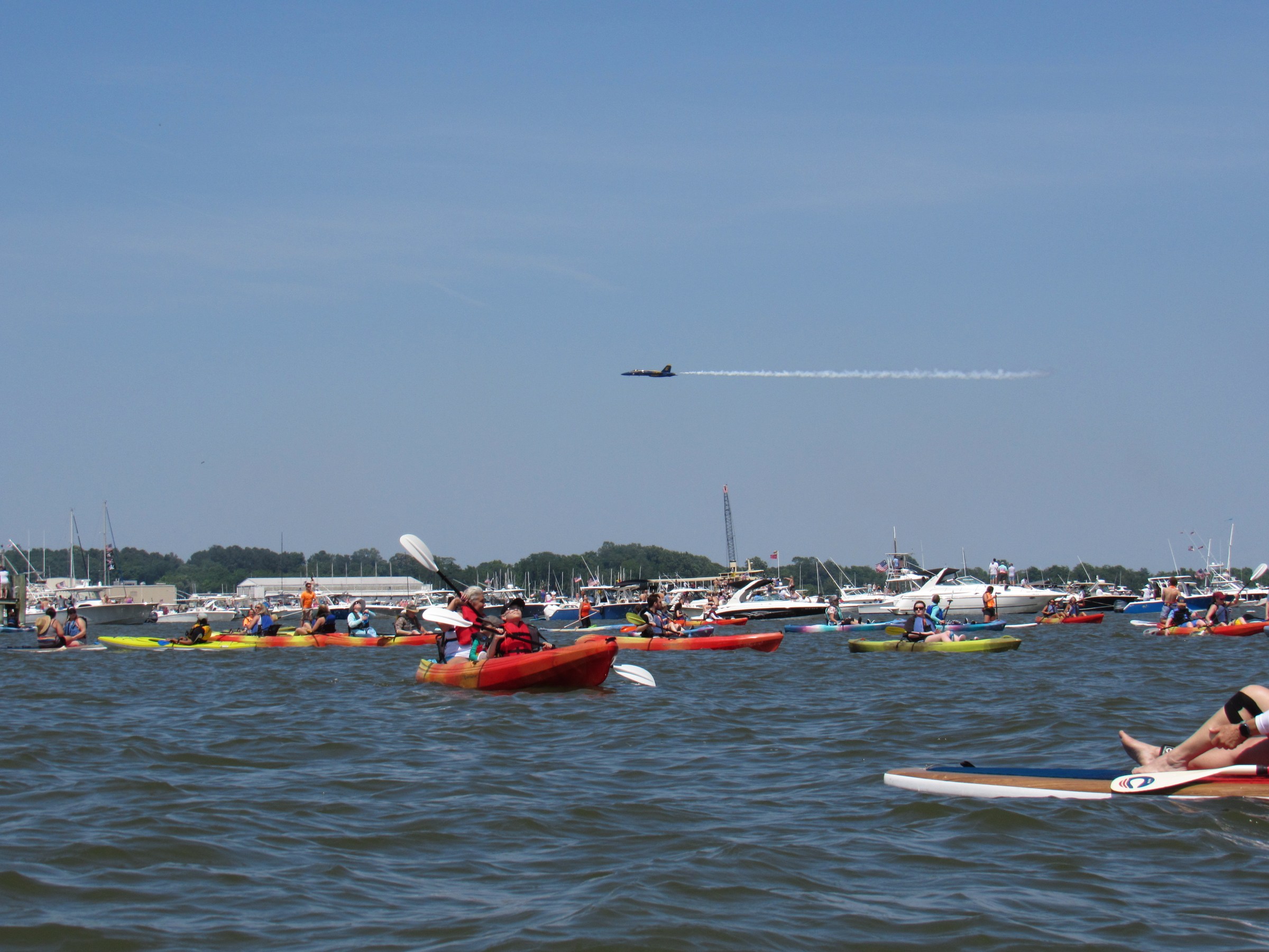 a group of people in a small boat in a body of water