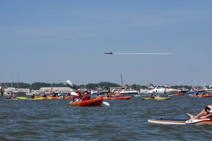 a group of people in a small boat in a body of water