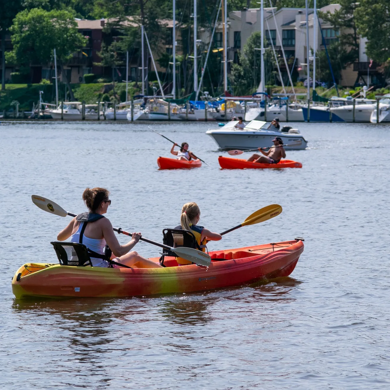a group of people in a small boat in a body of water