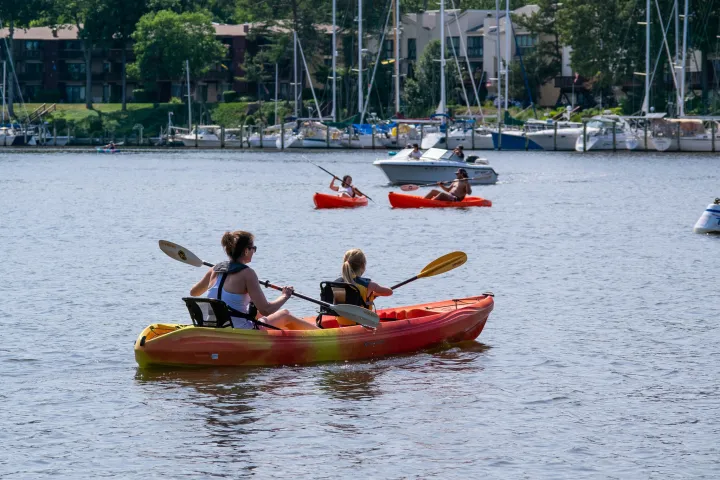a group of people in a small boat in a body of water