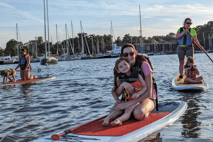 a group of people riding on the back of a boat in the water